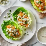 buffalo chicken salad with hot sauce and celery in a bowl