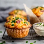 freshly baked ham and cheese breakfast muffins with melted cheddar and diced ham
