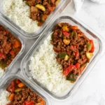 Unstuffed Pepper Bowls served in glass meal prep containers with rice and colorful peppers