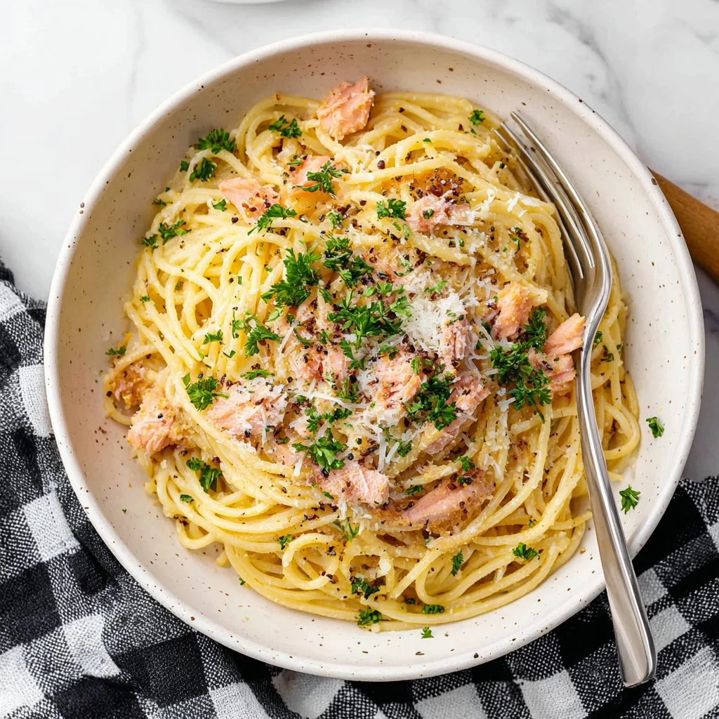 Creamy smoked salmon carbonara served in a bowl with parsley garnish