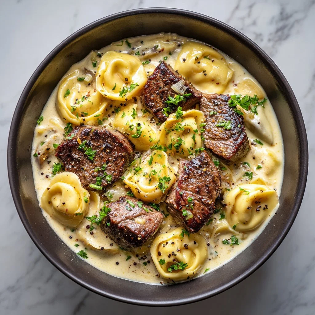 Cracked Garlic Steak Tortellini in creamy sauce served on a plate