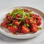 Delicious Crispy Chili Chicken garnished with herbs and spices